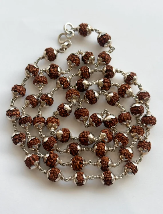 Silver-toned beaded necklace with brown textured beads and small silver flower spacers