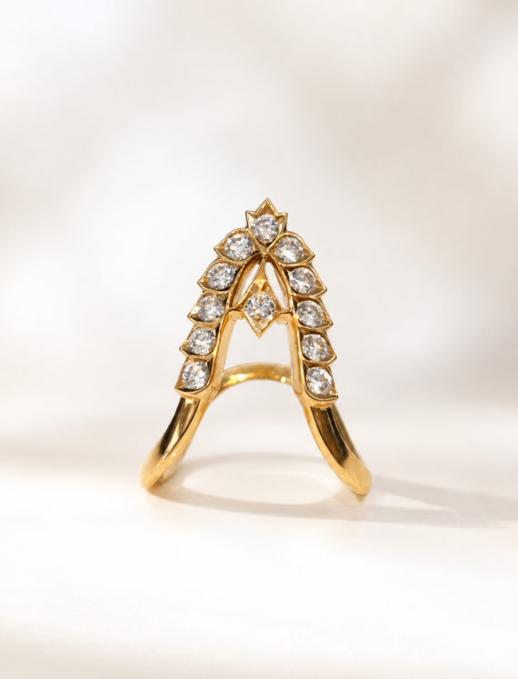 Gold ring featuring an arched, diamond-encrusted centerpiece with diamonds along the crown area.