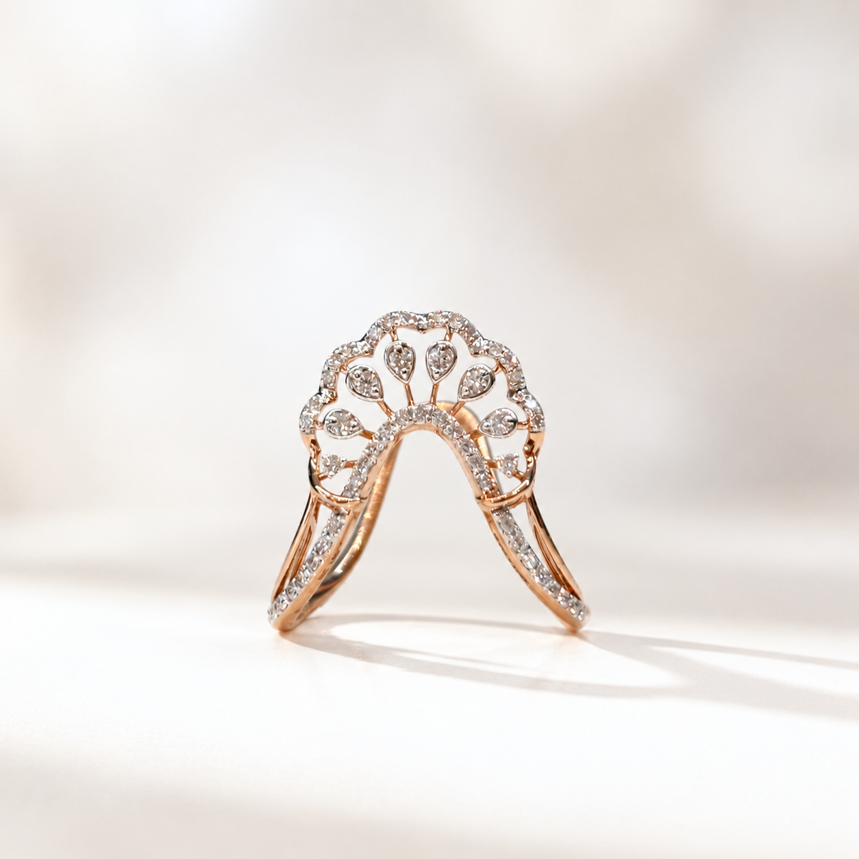 Rose gold engagement ring with a crown-like diamond halo and pavé band